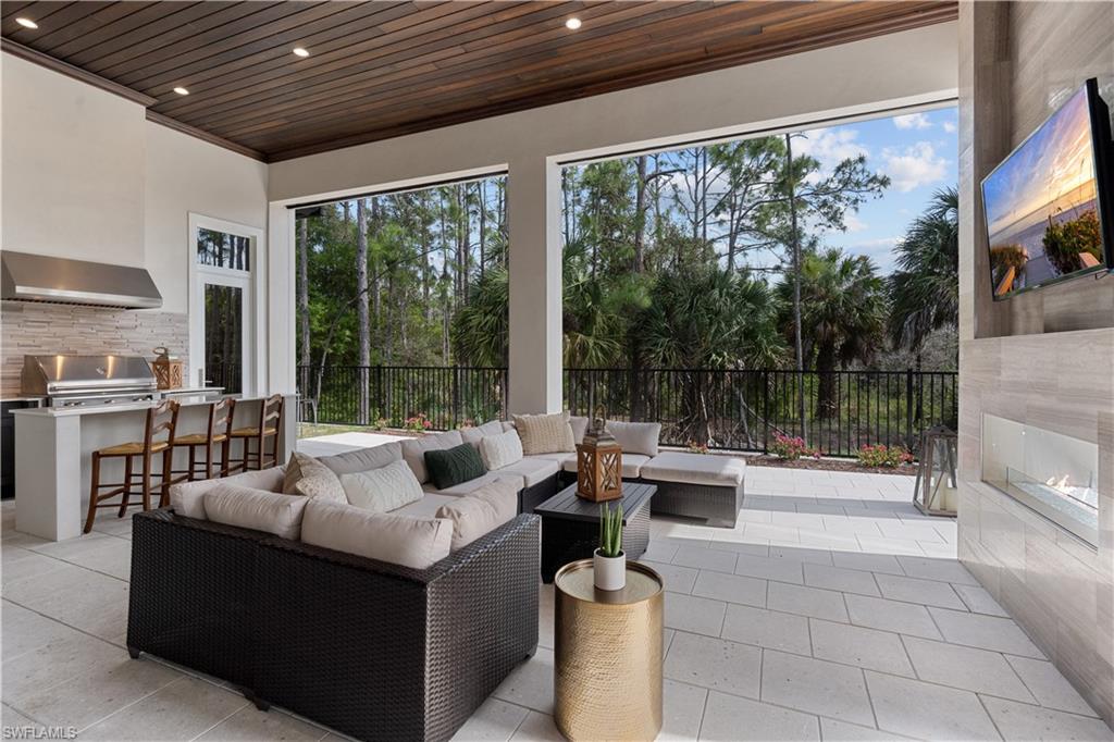 4478 Wayside Drive Naples, FL 34119 - Photo 16 of 31 a living room with furniture and a floor to ceiling window