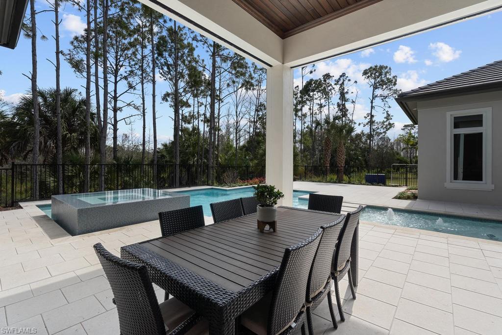 4478 Wayside Drive Naples, FL 34119 - Photo 17 of 31 a view of an outdoor dining space with a table and chairs