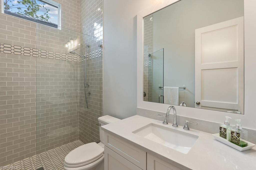 4478 Wayside Drive Naples, FL 34119 - Photo 25 of 31 a bathroom with a sink a toilet and shower