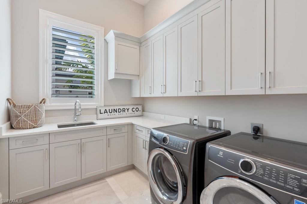 4478 Wayside Drive Naples, FL 34119 - Photo 28 of 31 a view of a kitchen that has a sink a washer and dryer in it