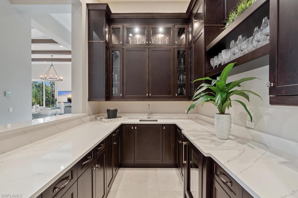 4478 Wayside Drive Naples, FL 34119 - Photo 7 of 31 a kitchen with a sink and cabinets