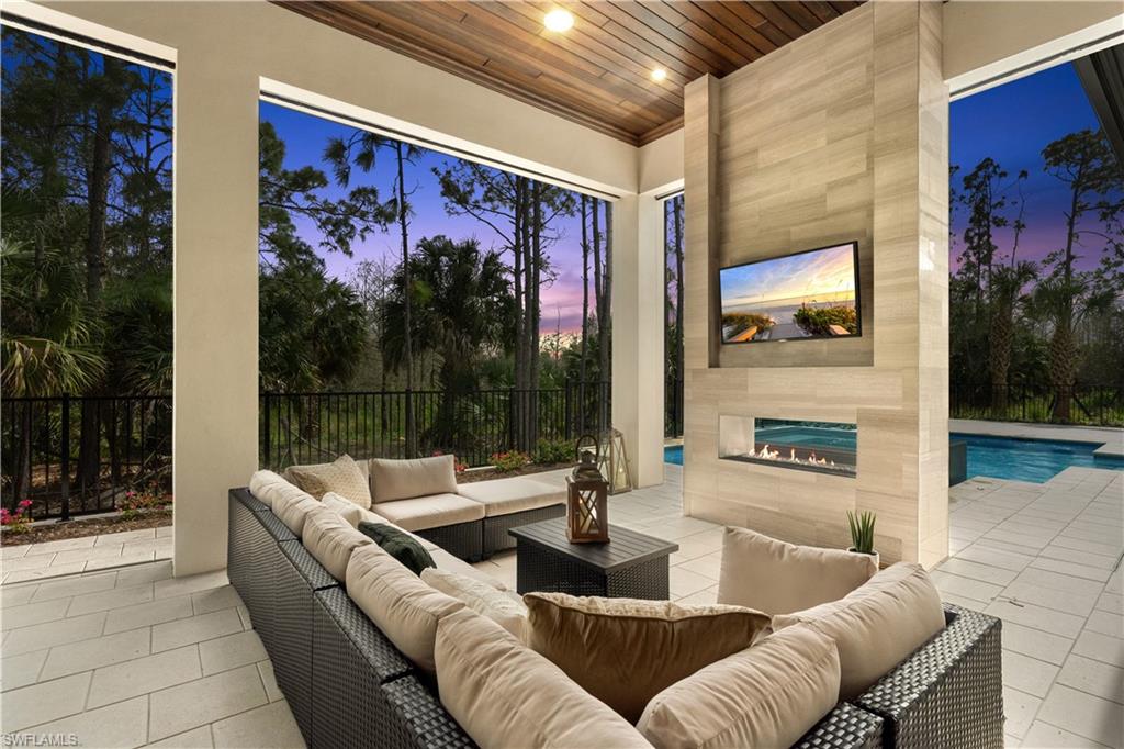 4478 Wayside Drive Naples, FL 34119 - Photo 9 of 31 a living room with furniture and a flat screen tv