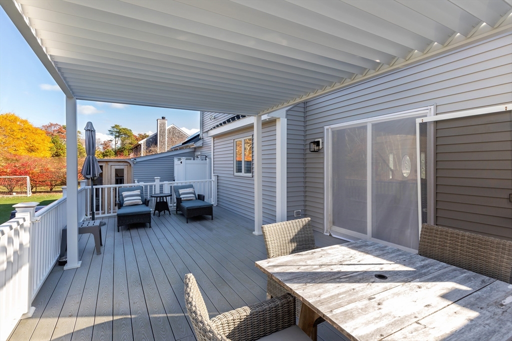 19 Oakbluff Road Bourne, MA 02562 - Photo 14 of 42 a balcony with furniture and wooden floor