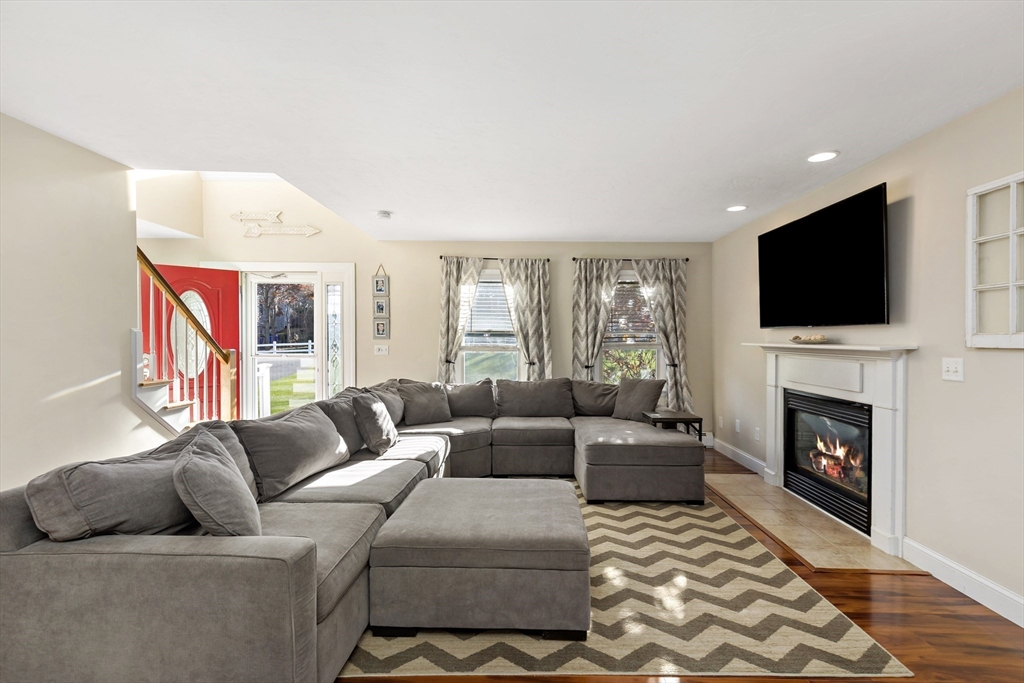 19 Oakbluff Road Bourne, MA 02562 - Photo 18 of 42 a living room with furniture a flat screen tv and a fireplace