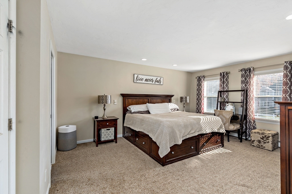 19 Oakbluff Road Bourne, MA 02562 - Photo 29 of 42 a spacious bedroom with a bed and a lamp