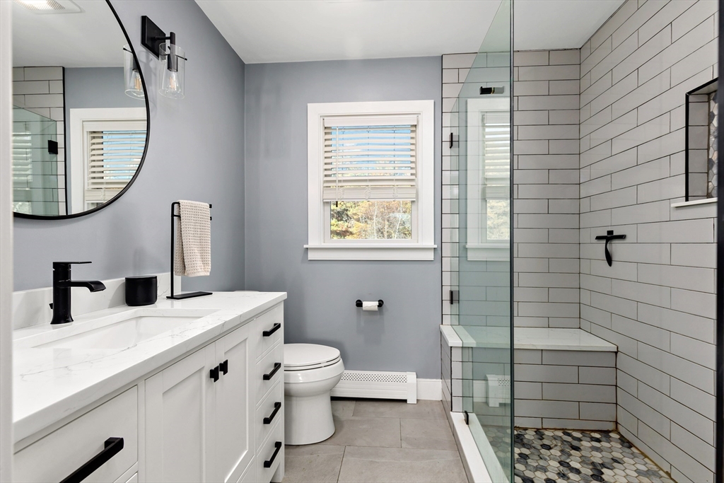 19 Oakbluff Road Bourne, MA 02562 - Photo 32 of 42 a bathroom with a granite countertop sink toilet and shower
