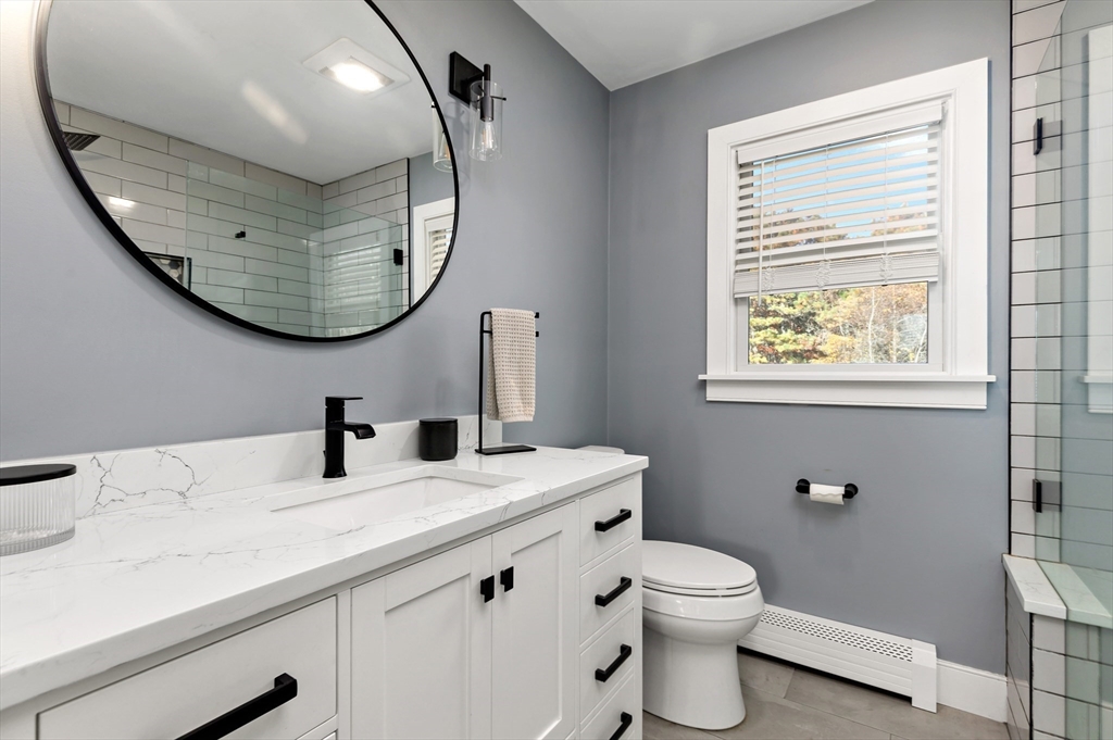 19 Oakbluff Road Bourne, MA 02562 - Photo 33 of 42 a bathroom with a sink a toilet and a mirror
