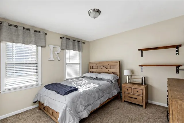 a bathroom with a granite countertop sink toilet and a mirror