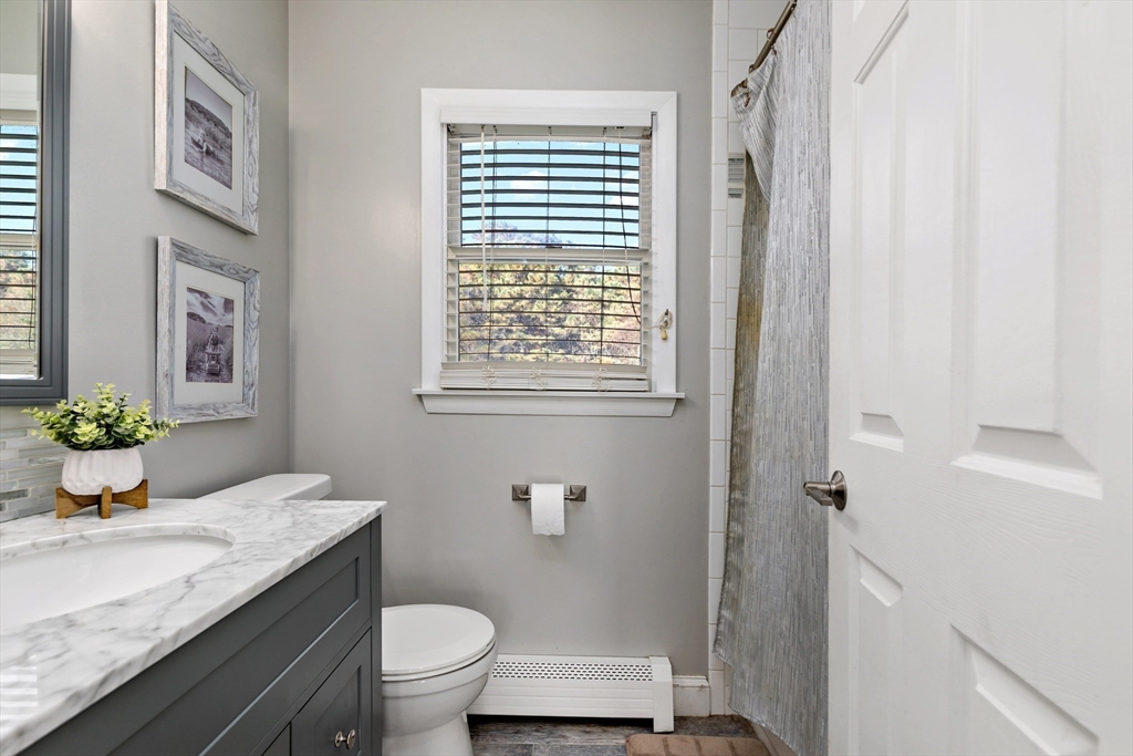19 Oakbluff Road Bourne, MA 02562 - Photo 38 of 42 a bathroom with a granite countertop sink toilet and a mirror