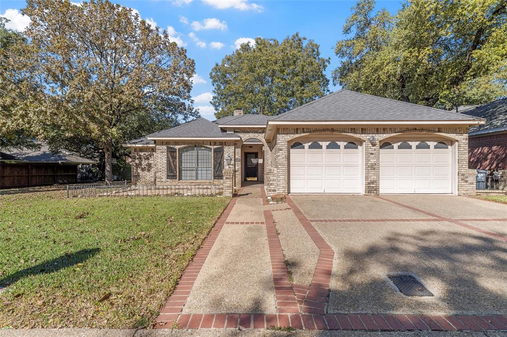 a front view of a house with a yard and a garage