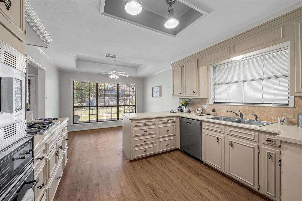 3601 Willow Bend Circle Waco, TX 76708 - Photo 13 of 37 a kitchen with stainless steel appliances sink stove and wooden floor