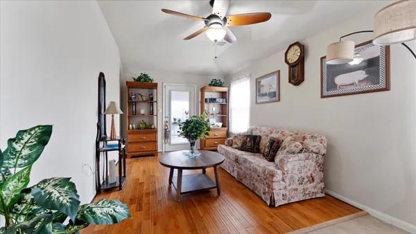a living room with furniture and wooden floor