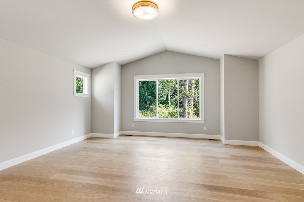 22921 31st Avenue Southeast Bothell, WA 98021 - Photo 11 of 16 an empty room with wooden floor and windows