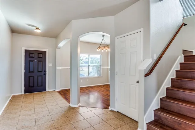 a view of an entryway with wooden floor