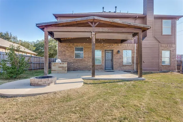 a bathroom with a granite countertop double vanity sink and mirror