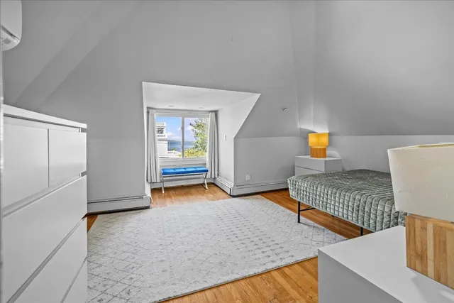 a living room with furniture a window and a potted plant