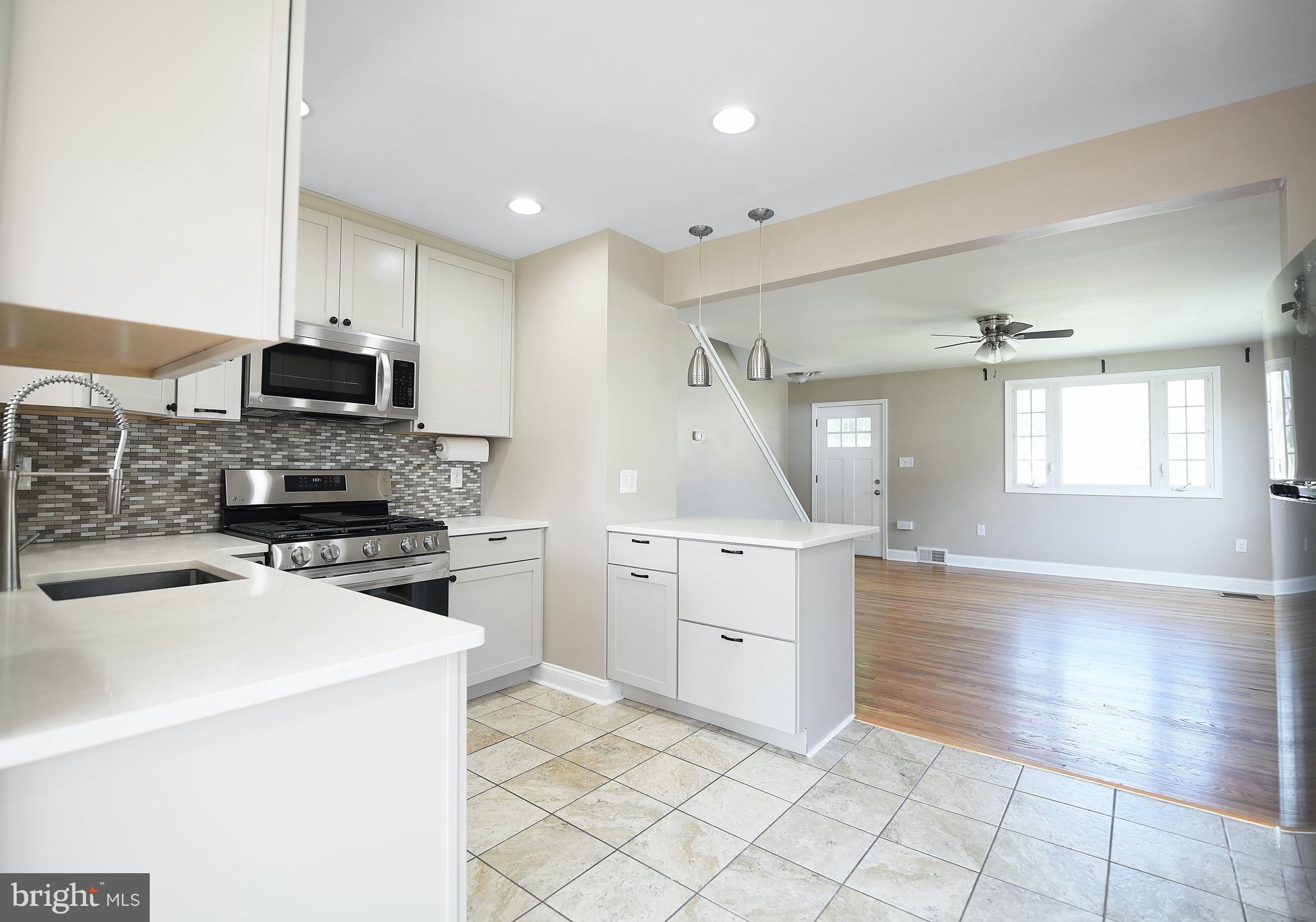 8205 Oakleigh Road Baltimore, MD 21234 - Photo 12 of 52 a kitchen with a stove a sink and a refrigerator