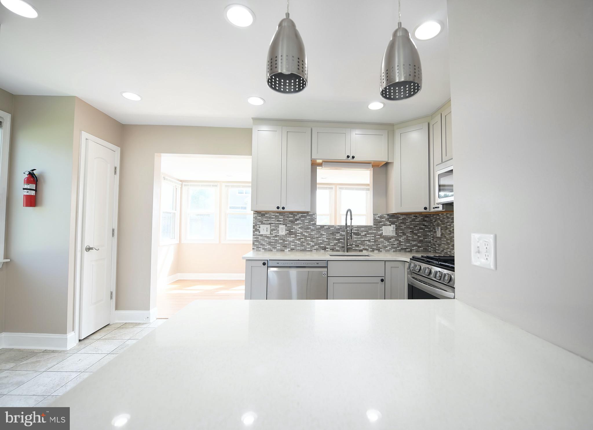 8205 Oakleigh Road Baltimore, MD 21234 - Photo 14 of 52 a large kitchen with stainless steel appliances granite countertop a sink and cabinets