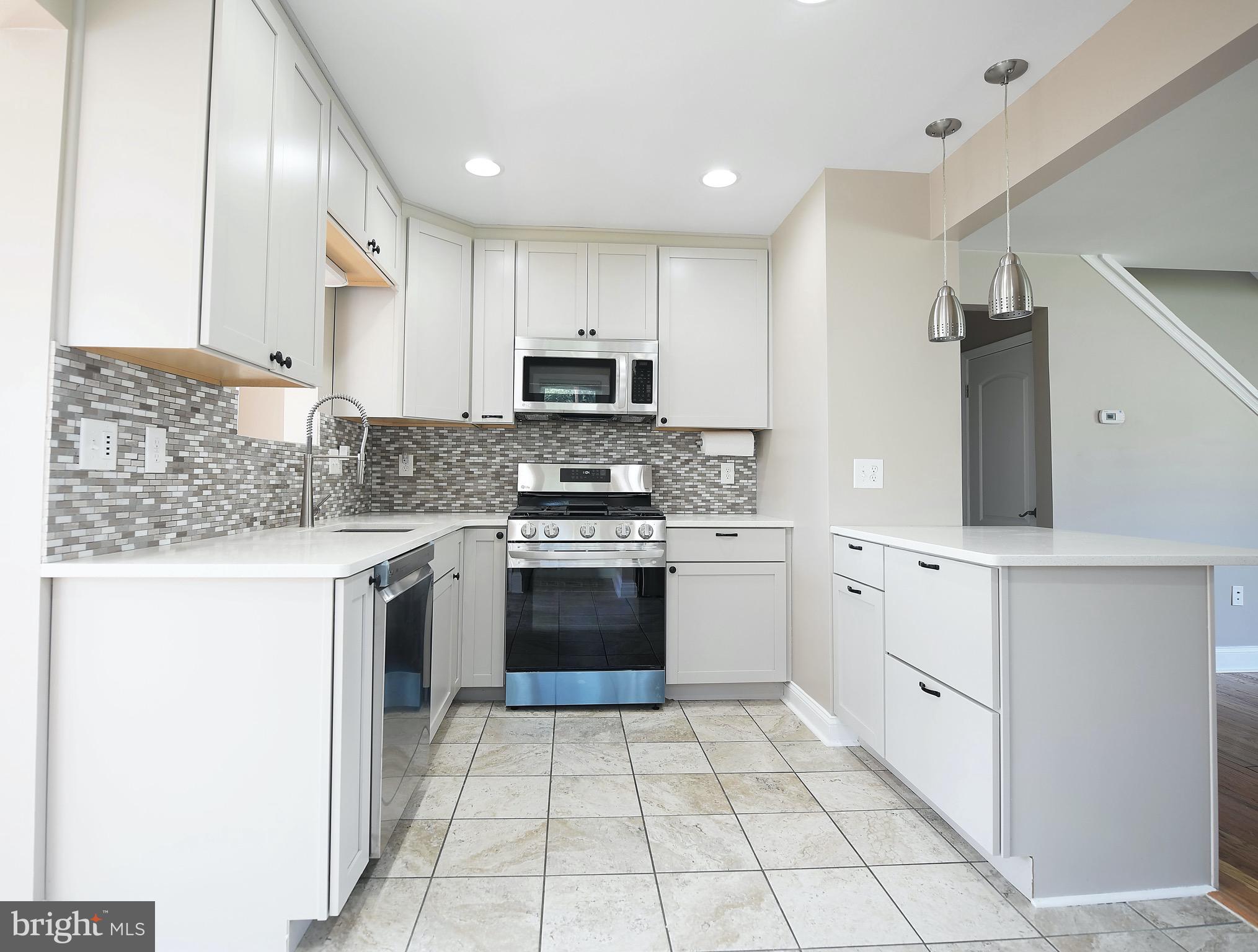 8205 Oakleigh Road Baltimore, MD 21234 - Photo 16 of 52 a kitchen with stainless steel appliances granite countertop a refrigerator sink and stove