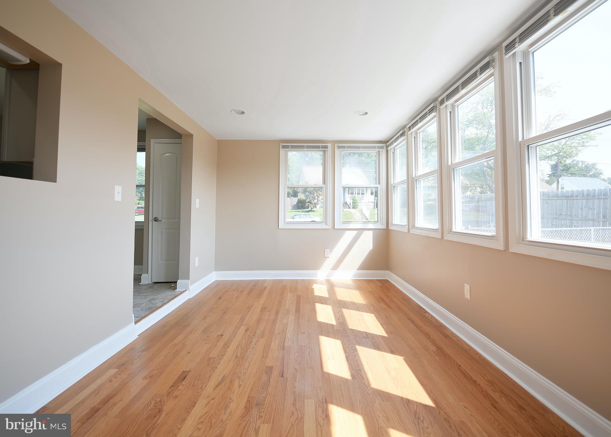 8205 Oakleigh Road Baltimore, MD 21234 - Photo 17 of 52 a view of an empty room with wooden floor and a window