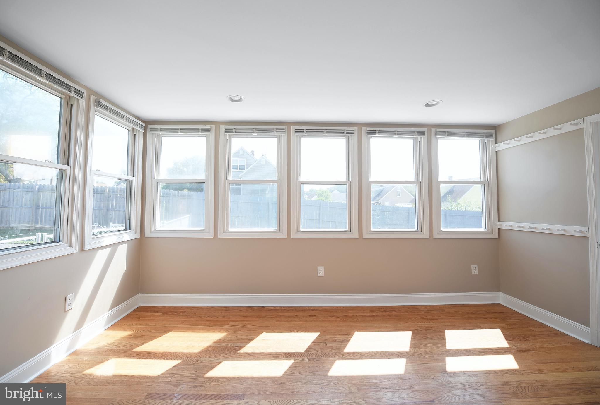 8205 Oakleigh Road Baltimore, MD 21234 - Photo 18 of 52 a view of empty room with wooden floor and fan