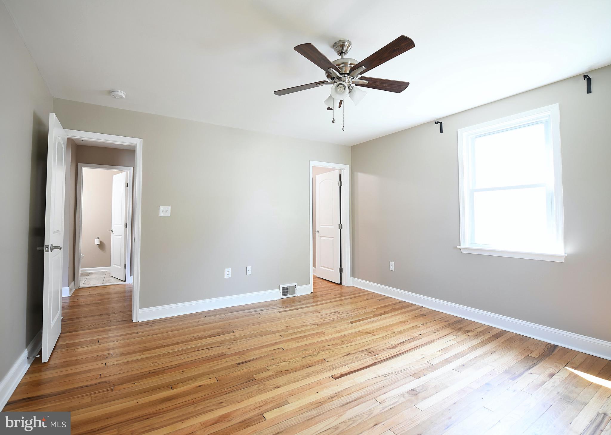 8205 Oakleigh Road Baltimore, MD 21234 - Photo 22 of 52 an empty room with wooden floor and windows