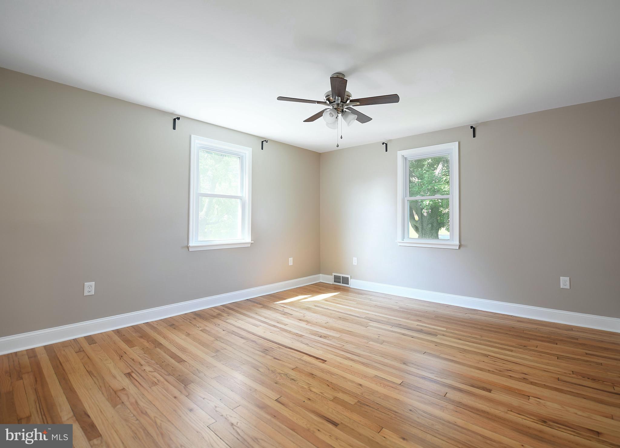 8205 Oakleigh Road Baltimore, MD 21234 - Photo 23 of 52 a view of empty room with wooden floor and fan
