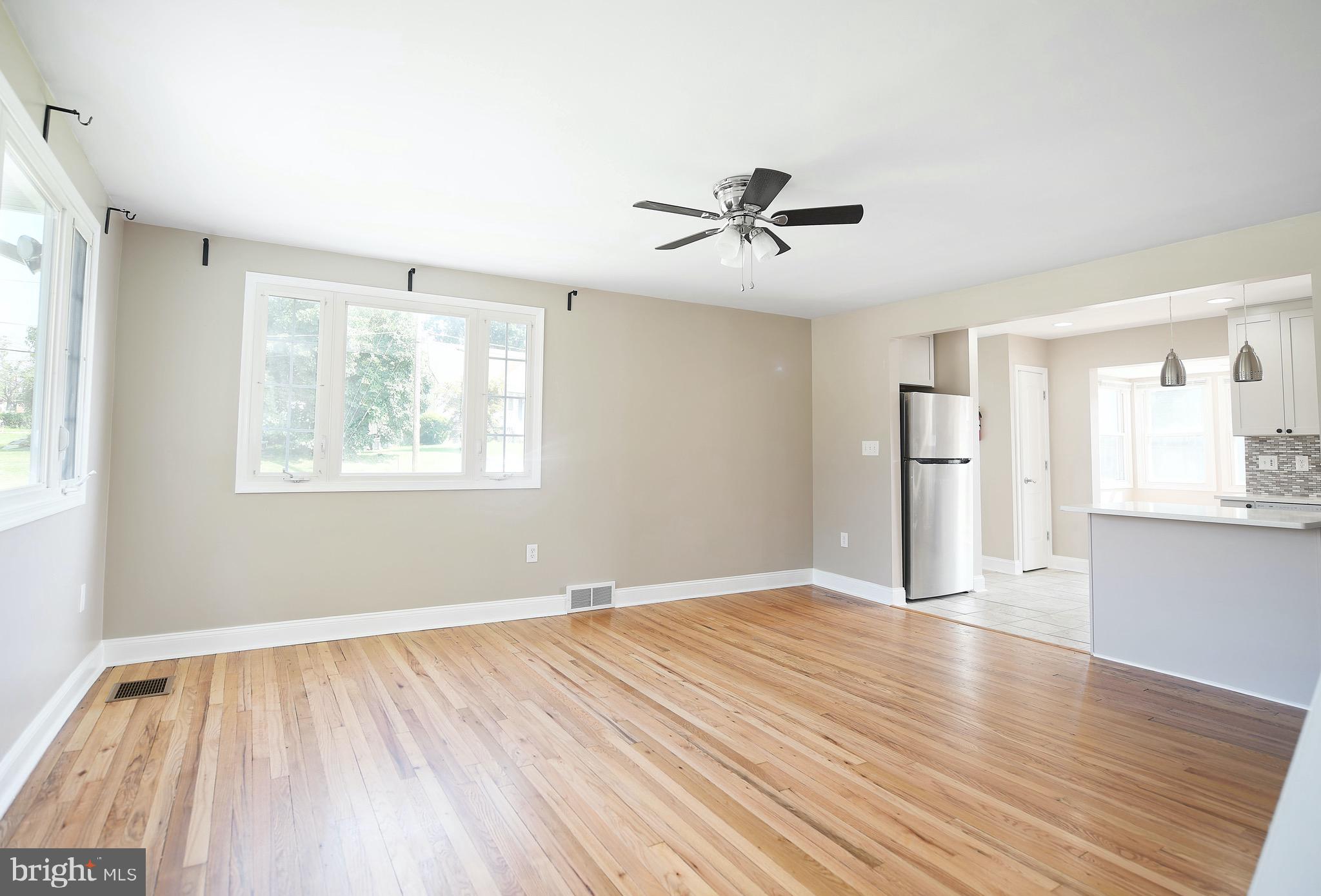8205 Oakleigh Road Baltimore, MD 21234 - Photo 28 of 52 a view of empty room with wooden floor and fan