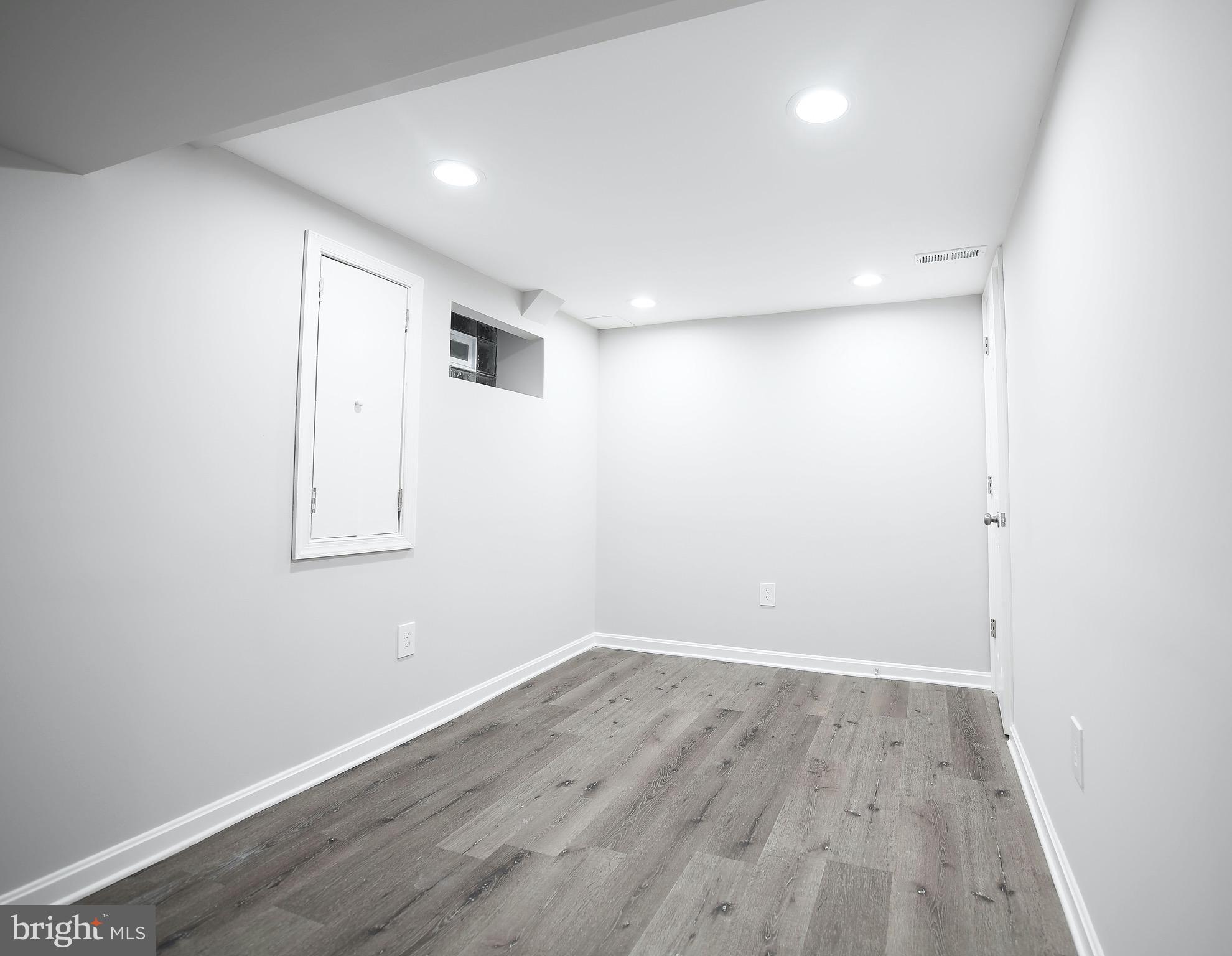 8205 Oakleigh Road Baltimore, MD 21234 - Photo 37 of 52 an empty room with wooden floor and windows