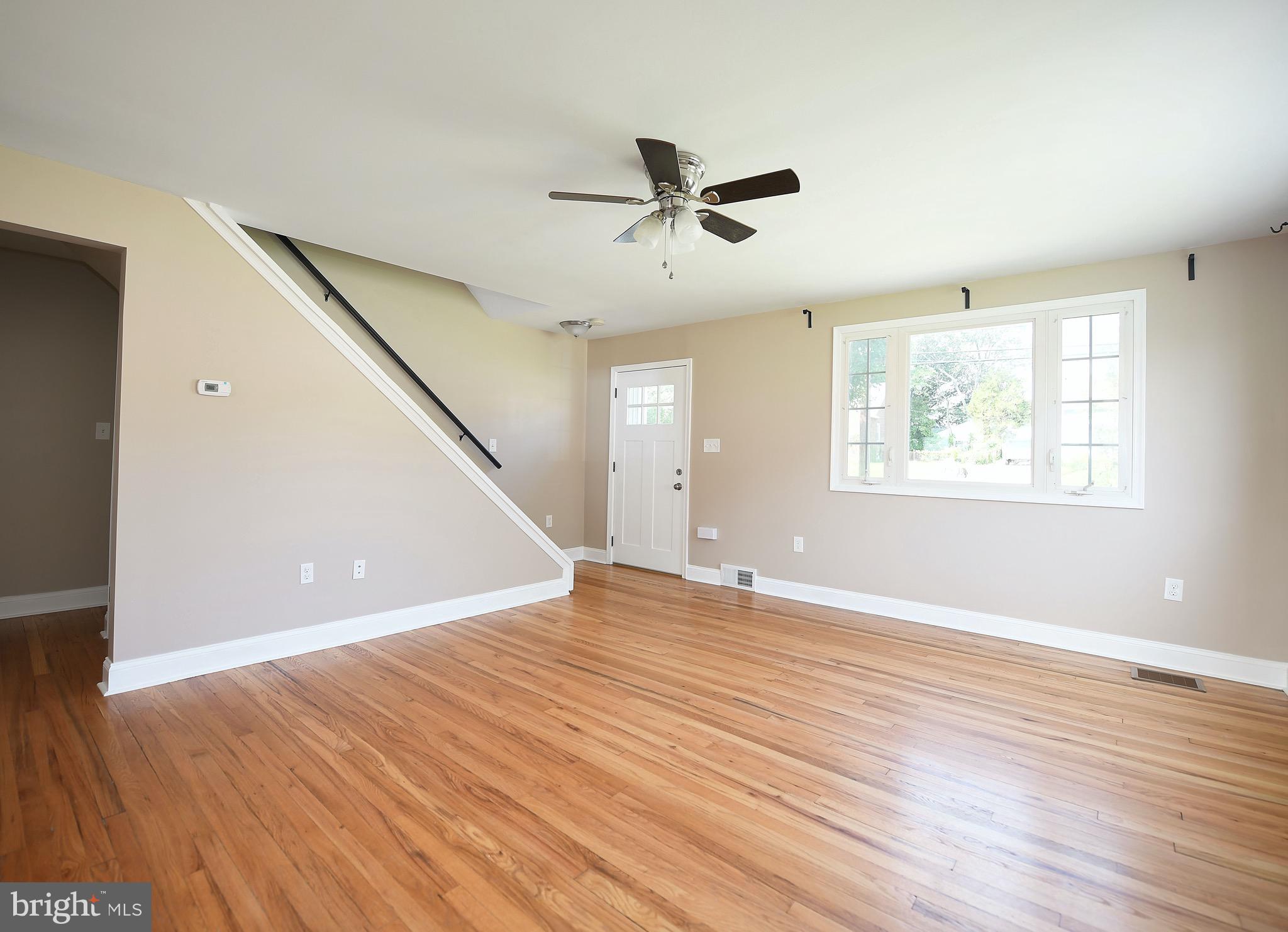 8205 Oakleigh Road Baltimore, MD 21234 - Photo 7 of 52 a view of an empty room with wooden floor and a window