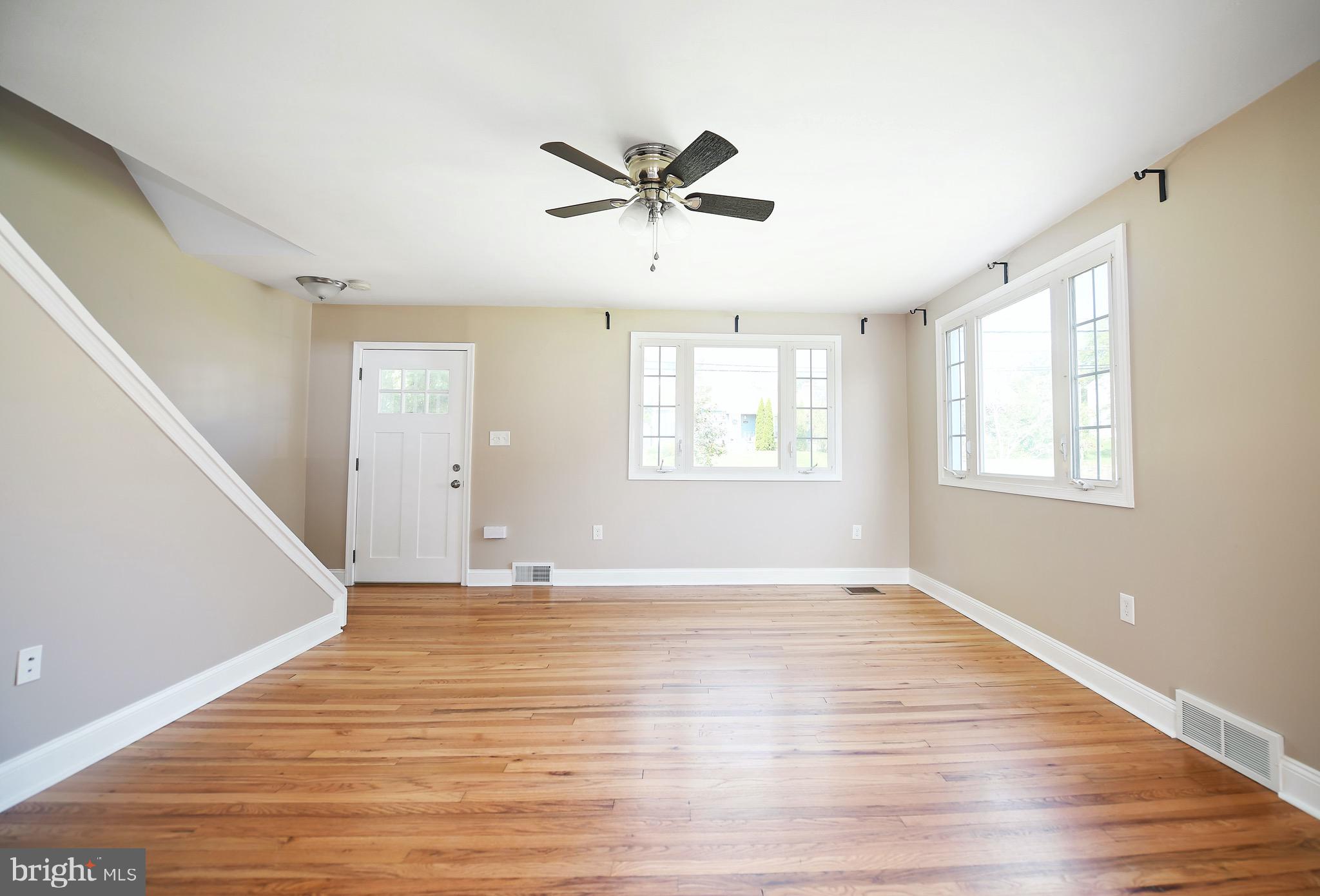 8205 Oakleigh Road Baltimore, MD 21234 - Photo 9 of 52 a view of empty room with wooden floor and fan