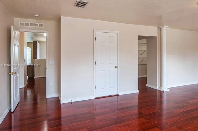 wooden floor with white walls