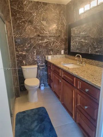 a view of bathroom with toilet sink and mirror