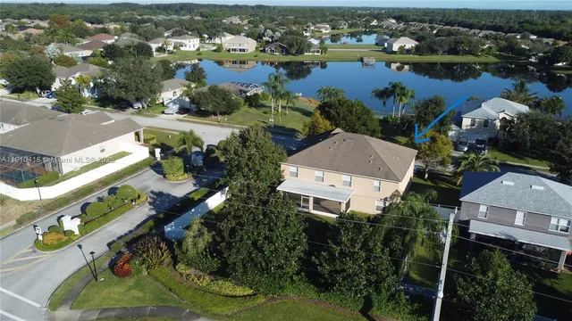 an aerial view of residential houses with outdoor space and river