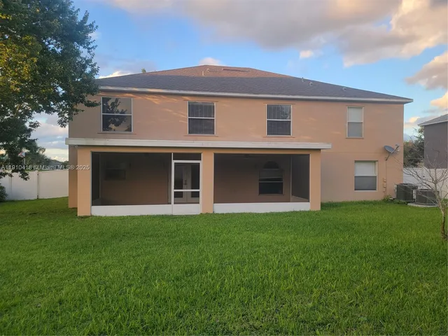 a front view of a house with a garden and yard