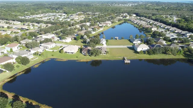 an aerial view of residential houses with outdoor space and river