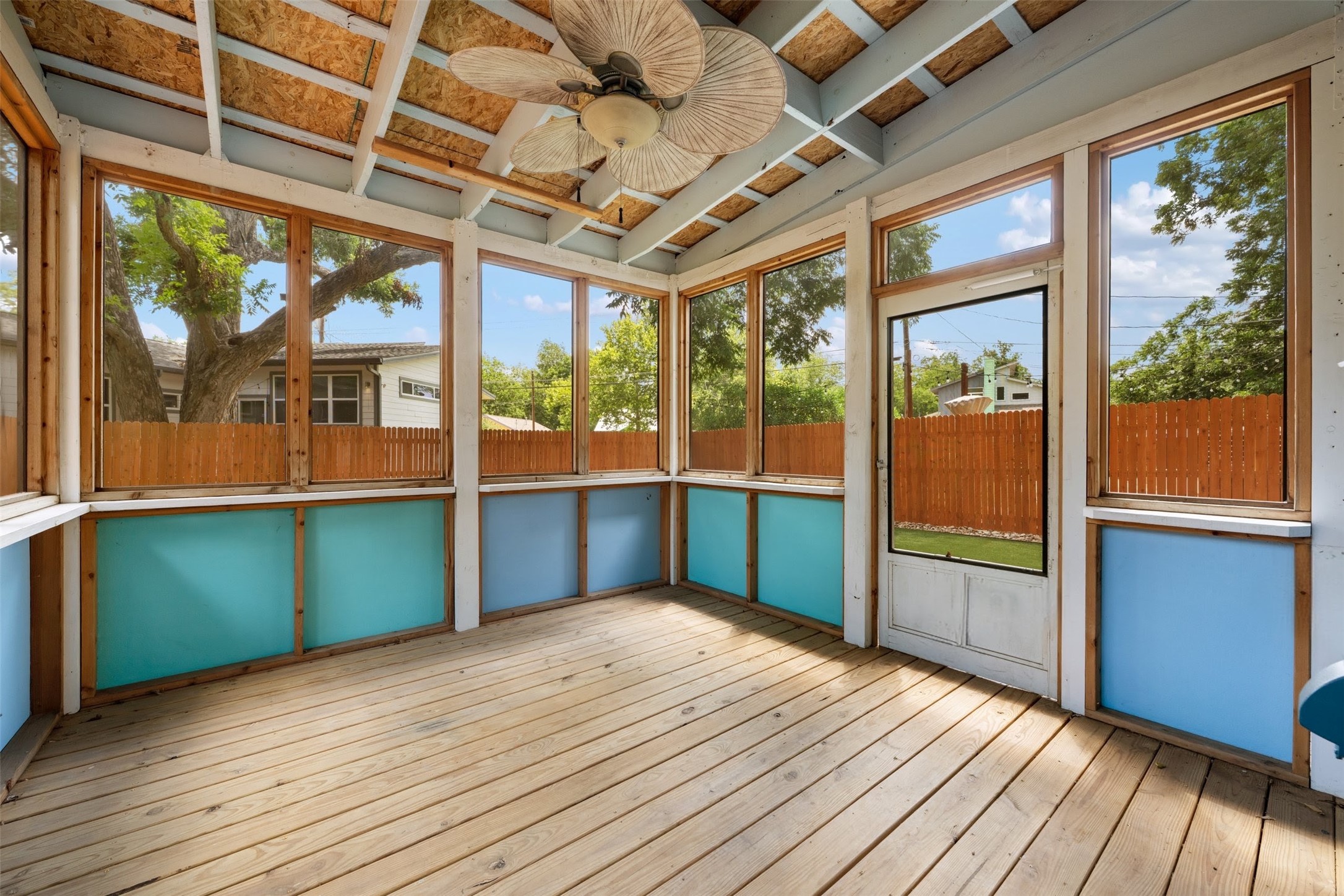 4912 Sara Drive, Unit A Austin, TX 78721 - Photo 26 of 28 Screened in porch with ceiling fan, outlets, and backyard access.