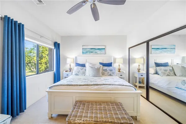 a bedroom with a large bed and a window