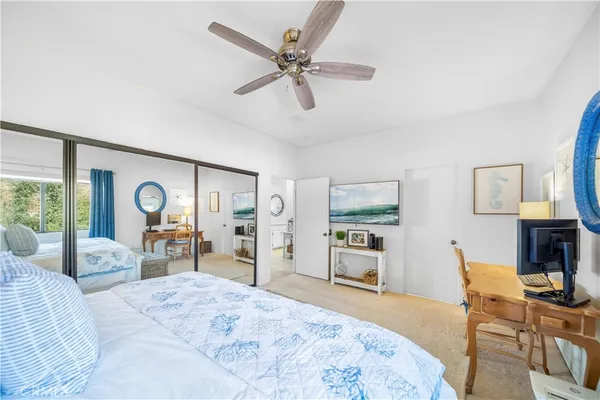 a bedroom with a bed and dresser with mirror