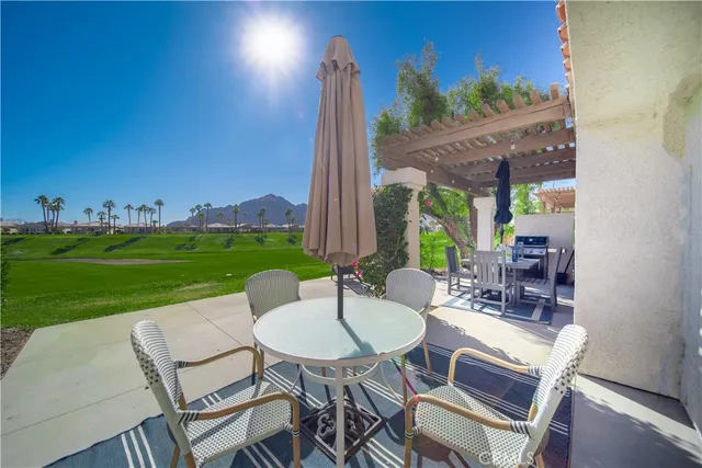 a view of a patio with a table chairs and a table