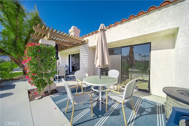 a view of a patio with table and chairs and potted plants