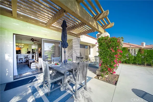 a view of patio with a table and chairs and potted plants