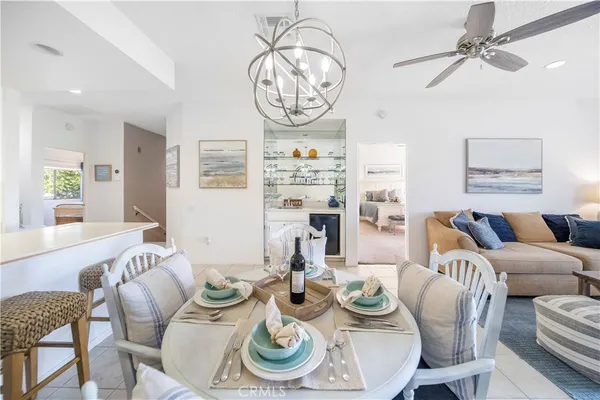a dining room with furniture a rug and a chandelier