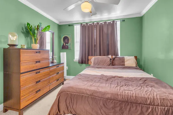 a bedroom with a bed and a dresser