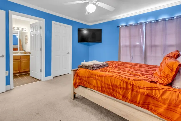 a bedroom with a bed and a flat screen tv