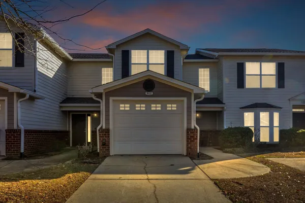a front view of a house with yard