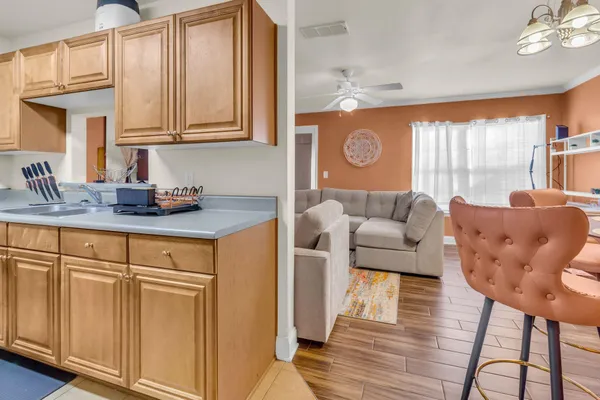 a living room with kitchen island furniture and a wooden floor