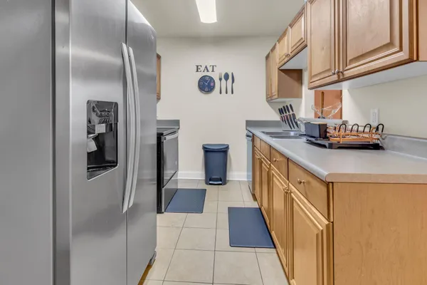 a kitchen with stainless steel appliances granite countertop a refrigerator and a stove
