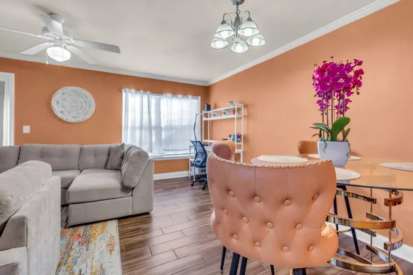 a living room with furniture and a chandelier