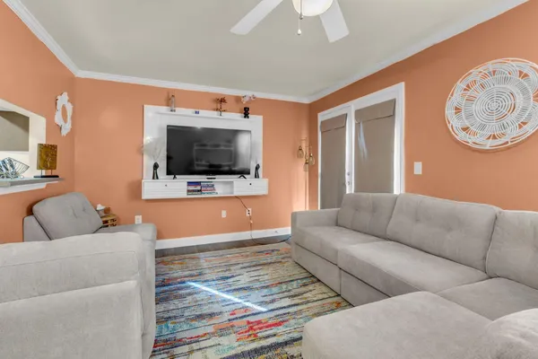 a living room with furniture and a flat screen tv